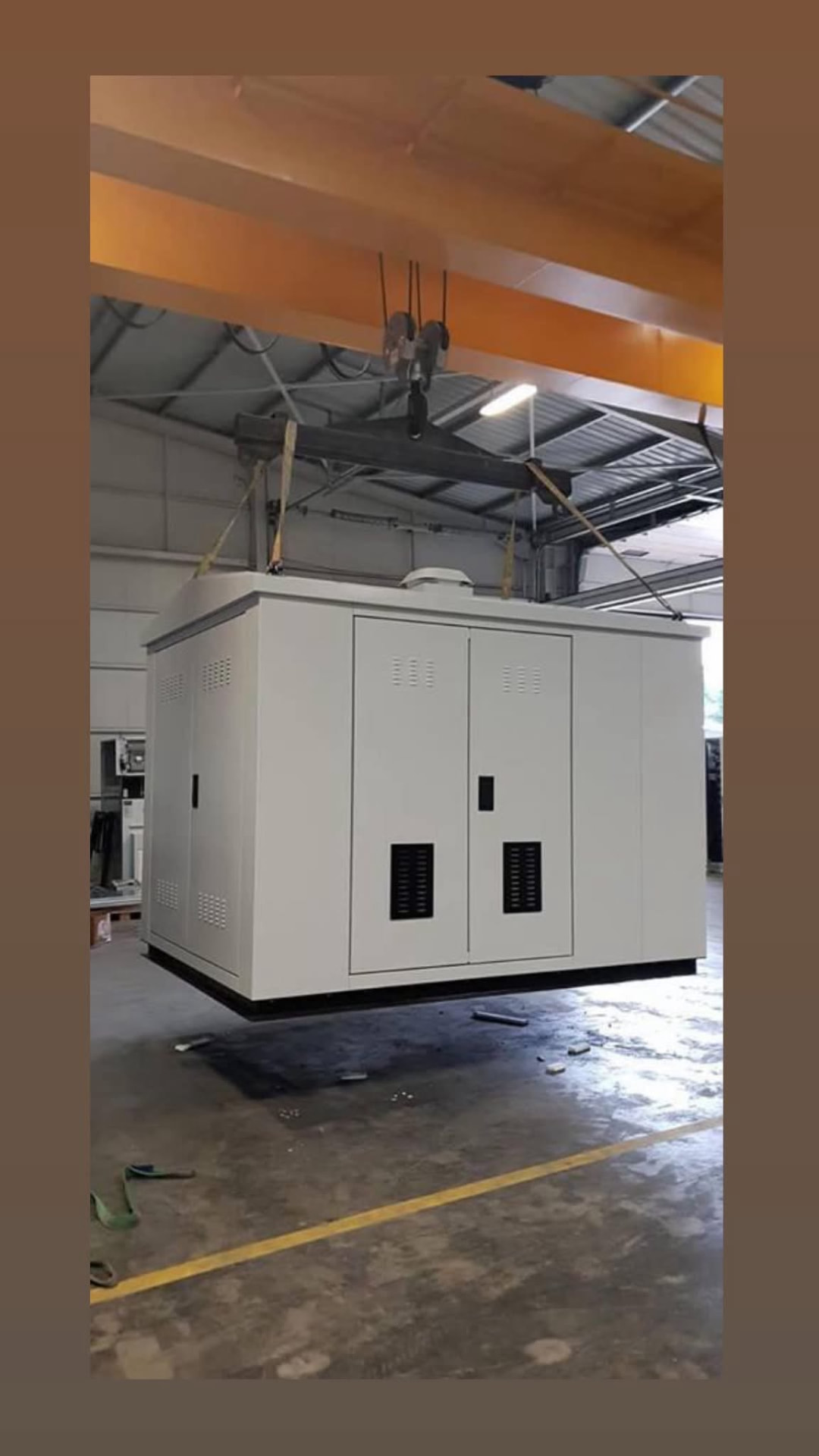 Finished sheet metal kiosk being moved by the factory crane